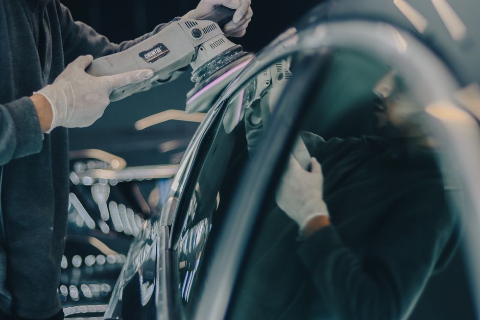 Professional auto detailer carefully working on a vehicle